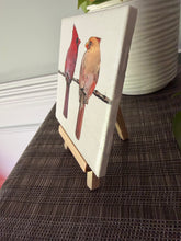 Male and female cardinal ceramic tile on natural wood easel