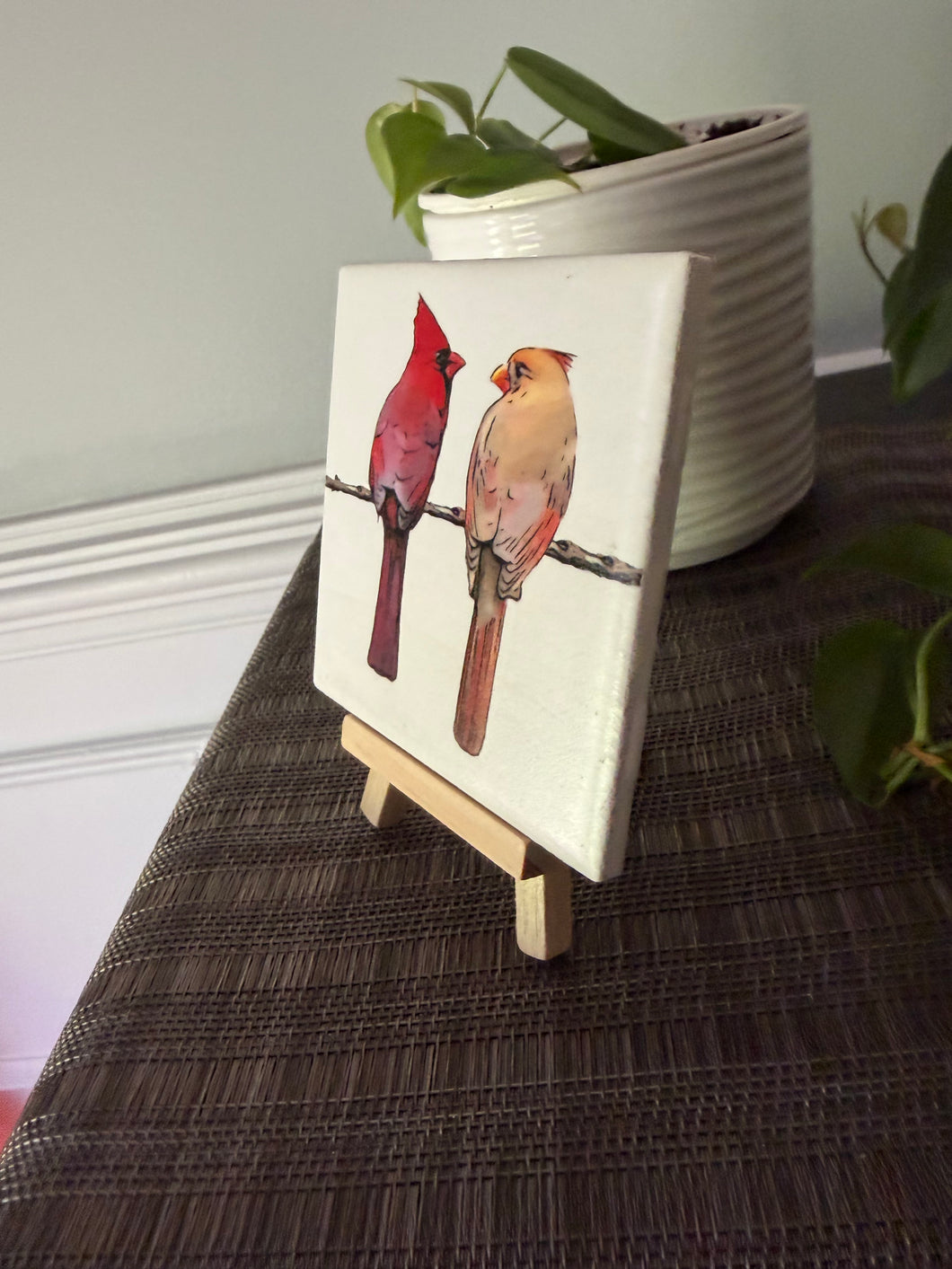 Male and female cardinal ceramic tile on natural wood easel
