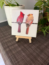 Male and female cardinal ceramic tile on natural wood easel
