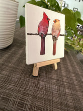 Male and female cardinal ceramic tile on natural wood easel